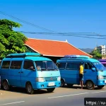 동티모르 대중교통 시스템 - A bustling street scene in Dili, East Timor, showcasing a lineup of colorful minivans (marshrutkas) ...